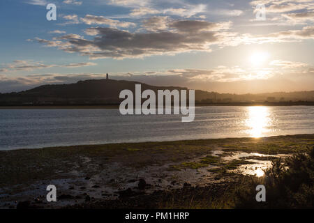 Soleil sur Strangford Lough avec Scrabo Tower sur Scrabo Hill visible. Newtownards, comté de Down, Irlande du Nord. Banque D'Images