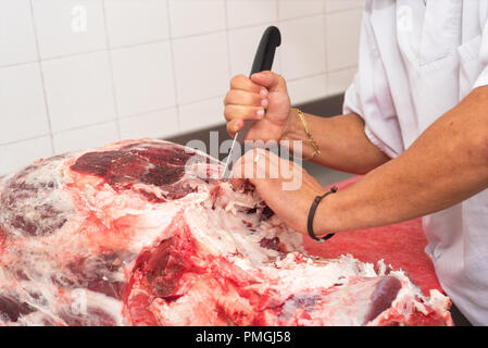 Couper la viande de boucherie dans la boucherie. Close up Banque D'Images