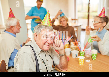 Groupe de personnes âgées au café la table à un anniversaire à la maison de retraite Banque D'Images