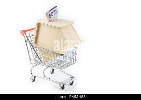 L'achat d'un nouveau concept de la chambre. L'argent en forme de maison fort dans un panier Banque D'Images