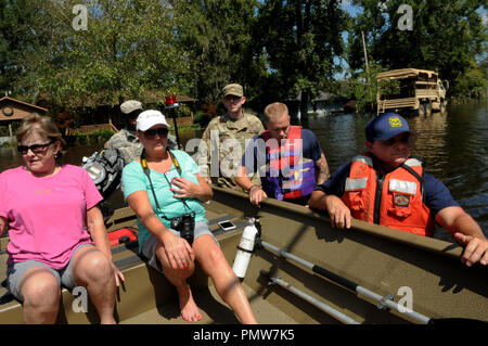 Conway, États-Unis. 18 sept 2018. 18 septembre 2018 - Conway, South Carolina, United States - Incendie Le personnel de sauvetage et gardes nationaux pousser un bateau transportant Jeannette Hughes (à gauche) et sa fille, Deana Hughes, donc ils peuvent récupérer des objets personnels de leur accueil qui est entouré par les eaux de crue à Conway, Caroline du Sud le 18 septembre 2018. La rivière Waccamaw est causant des inondations dans la région de Conway dans le sillage de l'ouragan Florence. (Paul Hennessy/Alamy) Crédit : Paul Hennessy/Alamy Live News Banque D'Images