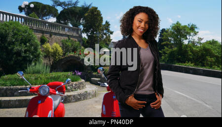 Portrait of cute African American Woman with vintage scooter Banque D'Images