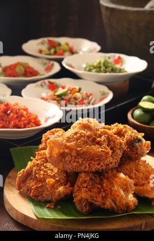Geprek Ayam. L'alimentation de rue de fusion de poulet frit du sud avec des condiments épicés indonésiens de cuisines régionales. Banque D'Images