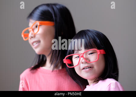 Deux petites soeurs avec de grandes lunettes Banque D'Images