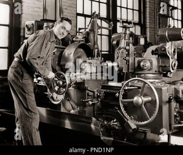 1940 SMILING MAN TRAVAILLANT UNE MACHINE DE TOUR DANS UNE USINE LOOKING AT CAMERA - j3890 HAR001 COMPÉTENCES HARS FIERTÉ MACHINES VUE ARRIÈRE MÉTIERS DU SECTEUR DE LA FABRICATION DE PRESSES DE FABRICATION CONTRÔLE TOUR RETOUR VOIR MID-ADULT MAN MI-NOIR ET BLANC DE L'ORIGINE ETHNIQUE CAUCASIENNE HAR USINES001 old fashioned Banque D'Images