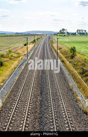 Vue de dessus d'une voie ferroviaire à grande vitesse français avec l'équipement de lignes aériennes faites de poteaux, caténaires, câbles et lignes électriques pour alimenter les trains. Banque D'Images