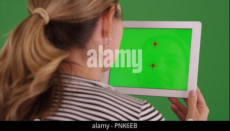 Femme blanche à l'aide de tablette avec incrustation sur l'affichage sur écran vert Banque D'Images