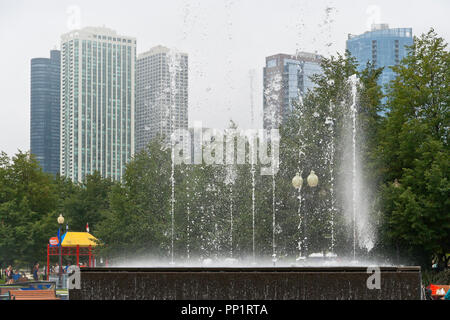 CHICAGO - le 28 août : des gouttes d'eau de la danse comme le parc de la fontaine de la passerelle joue en face de fog-enshrouded gratte-ciel par un après-midi d'été, le 2 août 2013 Banque D'Images