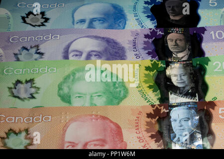 Billets de banque multicolores dans une pile. Close up d'argent canadien de pièces de tomber sur le dessus de l'argent en papier. Banque D'Images