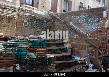 Livres empilés le long du mur extérieur de la Libreria Acqua Alta (librairie), Venise, Italie Banque D'Images