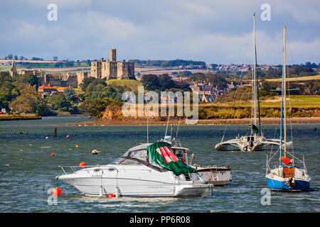 Château de Warkworth vu du port à l'Amblève dans tout l'estuaire et la rivière coquet avec voile et bateaux de pêche amarré le Northumberland England UK Banque D'Images
