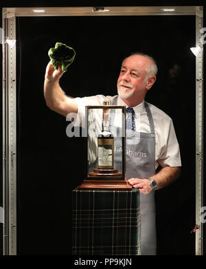 Danny McIlwraith de Bonhams nettoie l'armoire qui abrite le monde&Otilde;s les plus rares et les plus précieuses - une bouteille de whisky The Macallan Valerio Adami 60 ans 1926 avec une estimation de &pound;700,000-900,000. L'avant de la prochaine Vente Bonhams Whisky à leur maison de vente aux enchères d'Édimbourg, qui est défini à la fonction monde&Otilde;s les plus rares et les plus précieuses - une bouteille de whisky The Macallan Valerio Adami 60 ans 1926 avec une estimation de &pound;700,000-900,000. Banque D'Images