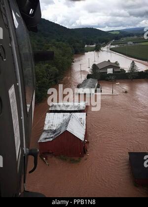 Un UH-60 Black Hawk, exploité par des soldats avec la 28e Brigade d'aviation de combat expéditionnaire, mouches par un quartier inondé près de Benton, Arkansas tout en menant des opérations de secours, le 13 août 2018. Banque D'Images