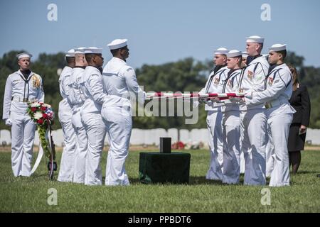 Les marins de la Marine américaine Garde de cérémonie tenir le drapeau des États-Unis au cours de l'honneur de funérailles U.S. Navy Lieutenant-commander William Liebenow dans l'article 62 du Cimetière National d'Arlington, Arlington, Virginie, le 23 août 2018. Le 7 août 1943, Liebenow skippé un lance-torpilles patrouille pour secourir les marins de PT-109 qui avait survécu à plusieurs jours sur les îles inhospitalières après un destroyer japonais avaient imposé leur bateau, tuant deux membres d'équipage. Parmi les personnes secourues était Liebenow bunkmate's, John F. Kennedy, puis 26. Pour ses actes d'héroïsme pendant la Seconde Guerre mondiale, il a reçu la médaille de Bronze et Silver Stars. Son Banque D'Images