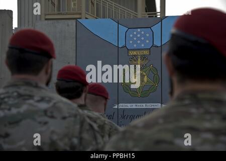 L'AÉRODROME DE BAGRAM, en Afghanistan (28 août 2018) -- Les membres de la communauté des opérations spéciales se rassembler devant une peinture murale au cours de la cérémonie de remise de la médaille d'honneur de l'US Air Force pour le sergent-chef. John Chapman sur l'aérodrome de Bagram, en Afghanistan, le 28 août 2018. La murale a été peinte en mémoire de Chapman pour ses actions héroïques lors de la bataille de Takur Ghar. Banque D'Images