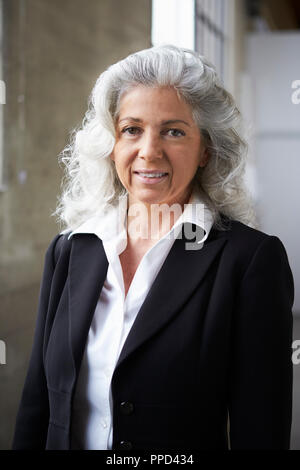 Blanc Senior businesswoman smiling to camera, vertical Banque D'Images