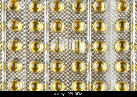 Emballage scellé avec capsules transparentes. Macro fond. Banque D'Images