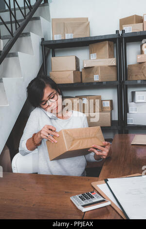 Femme compte sur paquet sur une étagère Banque D'Images