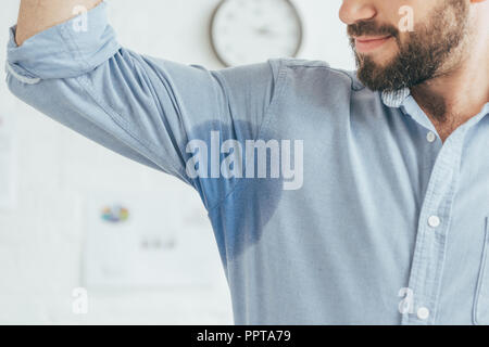 Portrait d'homme en sueur montrant blue chemise mouillée Banque D'Images