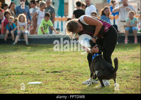 Florence, Italie - 2018, 22 Septembre : Woman throwing frisbee (disque volant) pour le chien à "suivre" Votre animal Expo 2018. Banque D'Images