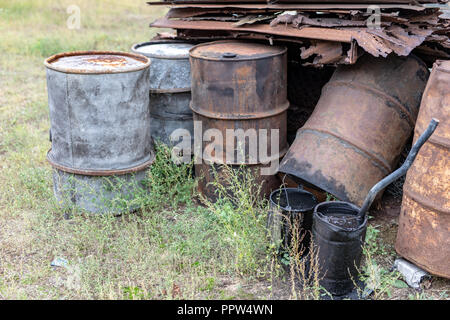 Vieux barils de diesel. Conteneurs métalliques pour l'huile sur le parc à ferrailles. Saison de l'automne. Banque D'Images