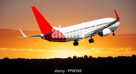 Un avion de ligne à réaction volant au-dessus d'un gros plan de couleur jaune et orange dans un stratus ciel couleur abricot. La beauté de l'atmosphère, Sydney. Banque D'Images