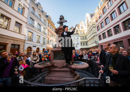 29 septembre 2018, Hessen, Frankfurt/Main : un acteur de la Volksbühne vol Francfort en costume historique se dresse sur la Stoltze fontaine et parle à les visiteurs du marché du poulet. Le 'Nouveau' de la vieille ville de Francfort sera ouvert ce week-end avec un festival. Photo : Andreas Arnold/dpa Banque D'Images