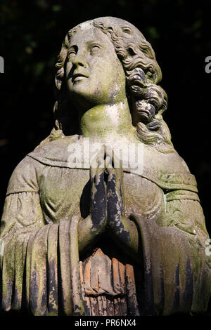 Une statue de femme priant sur une pierre tombale dans le cimetière de Dean à Édimbourg Banque D'Images