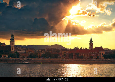 Coucher du soleil sur les toits de la ville de Budapest. Eglise de Saint Anne sur le côté Buda du Danube est visible à partir d'un bateau sur le Danube à Budapest, Hongrie Banque D'Images