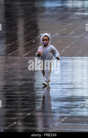 Londres, Royaume-Uni. 1 octobre 2018. Natalie Bell : une granddaugter jouit du reflet au sol dans l'entrée - Hyundai Commission : Tania Bruguera est à la Tate Modern - un ouvrage construit autour de la migration à l'aide d'un sol sensible à la chaleur. Dans le cadre de l'installation, elle collabore avec 21 personnes locales y compris Natalie Bell, un activiste local honorée pour son travail dans la communauté en ayant la Chaufferie renommé après elle. Une grande échelle, interactive et multi-facettes au sein de la commission Hall Turbine à partir du 2 octobre 2018 au 24 février 2019. Crédit : Guy Bell/Alamy Live News Banque D'Images