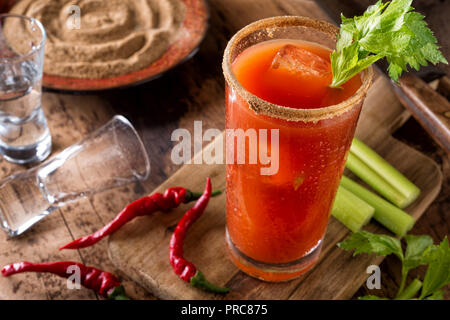 Un délicieux cocktail bloody caesar épicé avec de la vodka, jus de tomate, jus de palourdes, sauce chaude et le céleri. Banque D'Images