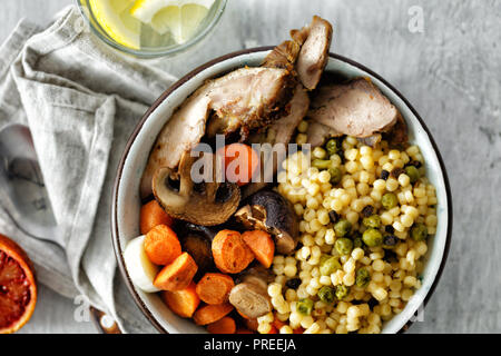 Une alimentation saine avec des carottes et le porridge dans un bol de champignons sur une table en bois blanc, vue du dessus. Concept d'aliments sains Banque D'Images