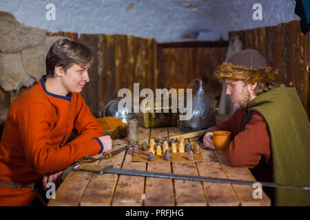 Deux hommes en costume ethnique russe populaire médiéval jeu jeu de stratégie - tafl. Folk, de concurrence et de concept traditionnel Banque D'Images