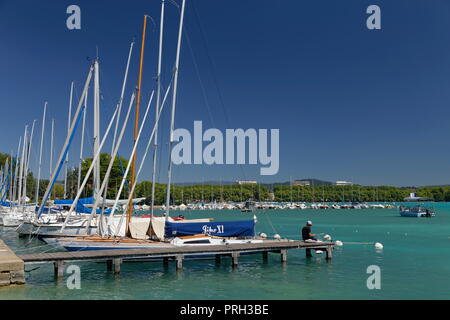 Pêche jetée par personne sur voiliers sur les eaux cristallines du lac d'Annecy France Banque D'Images