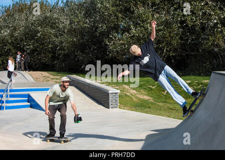 Une planche d'être filmé effectuant un tour sur une rampe à vagues de béton à Newquay en Cornouailles. Banque D'Images