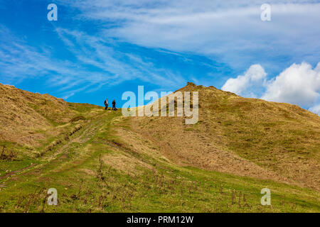 Deux hommes descendent une pente raide tracé sur la mine désaffectée et fonctionnement de la carrière sur Titterstone Clee Hill, London, UK Banque D'Images