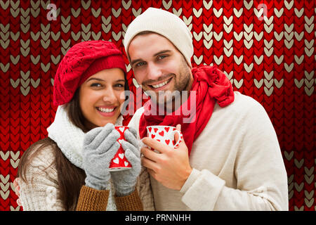 Image composite de l'hiver couple holding mugs Banque D'Images