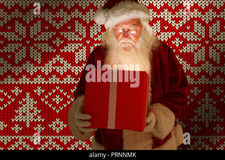Image composite d'un père noël de l'ouverture d'un cadeau de noël magique Banque D'Images