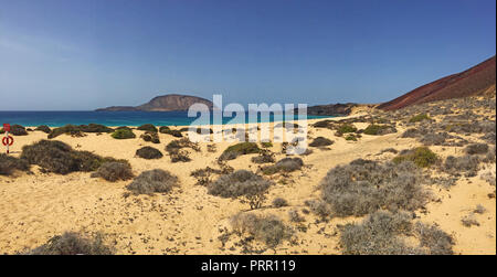 Lanzarote, Canaries : le Paradise Beach Playa de las Conchas et la montagne rouge Montana Bermeja dans le nord de l'île de La Graciosa Banque D'Images