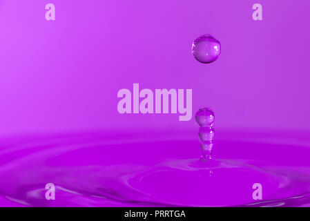 Des gouttelettes d'eau colorée de rebondir sur l'eau Banque D'Images