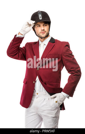 Beau jeune cavalier en uniforme et casque à l'écart isolated on white Banque D'Images