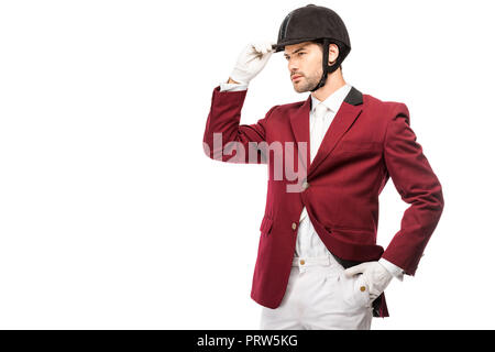 Jolie jeune cavalier en uniforme et casque à l'écart isolated on white Banque D'Images