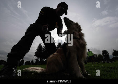 Bogota, Colombie. 4ème Oct, 2018. Membre de l'équipe d'enquête technique colombienne (ICT) prend part à une cérémonie de reconnaissance avec un chien à Bogota, Colombie, le 4 octobre 2018. Une cérémonie de reconnaissance pour souligner et reconnaître le travail des canines et équidés qui servent à Bogota a eu lieu ici pour marquer la Journée Mondiale des Animaux le jeudi. Credit : Jhon Paz/Xinhua/Alamy Live News Banque D'Images