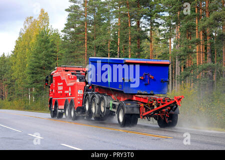 Salo, Finlande. 28 septembre 2018 : remorque de transport de gravier remorqué par une dépanneuse lourde d'Hinauspalvelu Vikman, le long de la route un jour de pluie. Banque D'Images