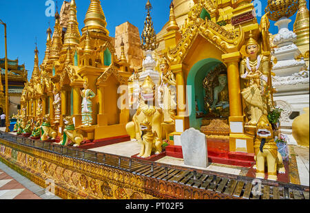 Explorez les petites stupas extérieur de Shwedagon Zedi Daw avec Nat des statues et des créatures mythiques-gardes autour de l'images du Bouddha, Yangon, Myanmar. Banque D'Images