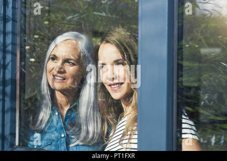 Mère et fille à la fenêtre de Banque D'Images