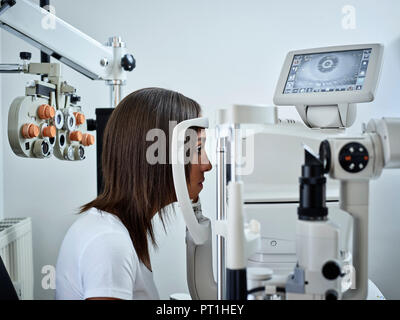 Opticien, une jeune femme au cours de l'essai d'oeil Banque D'Images