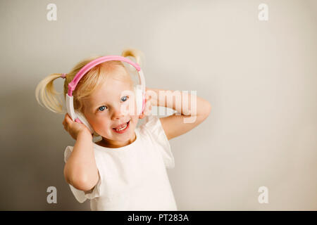 Portrait de petite fille à l'écoute de la musique avec des écouteurs dancing Banque D'Images