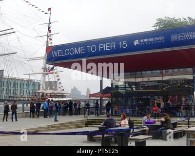 Les touristes en face du quai 15 sur l'East River, New York, NY. Banque D'Images