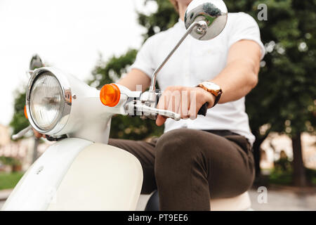 Portrait of Young business man riding scooter rétro sur l'extérieur Banque D'Images